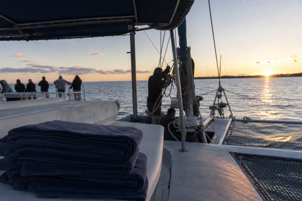 Catamaran deck with sunset sky, no text, no logos, no people