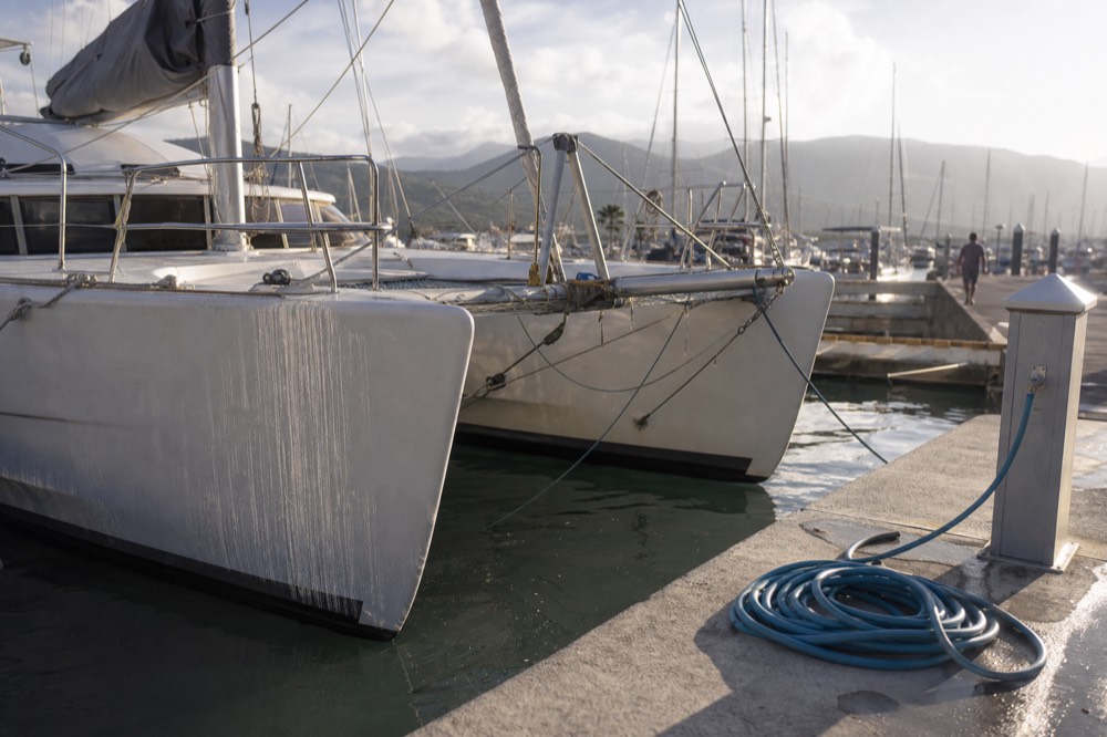 Sunset light on the twin hulls of a catamaran moored at a Key West marina, no text, no logos, no people