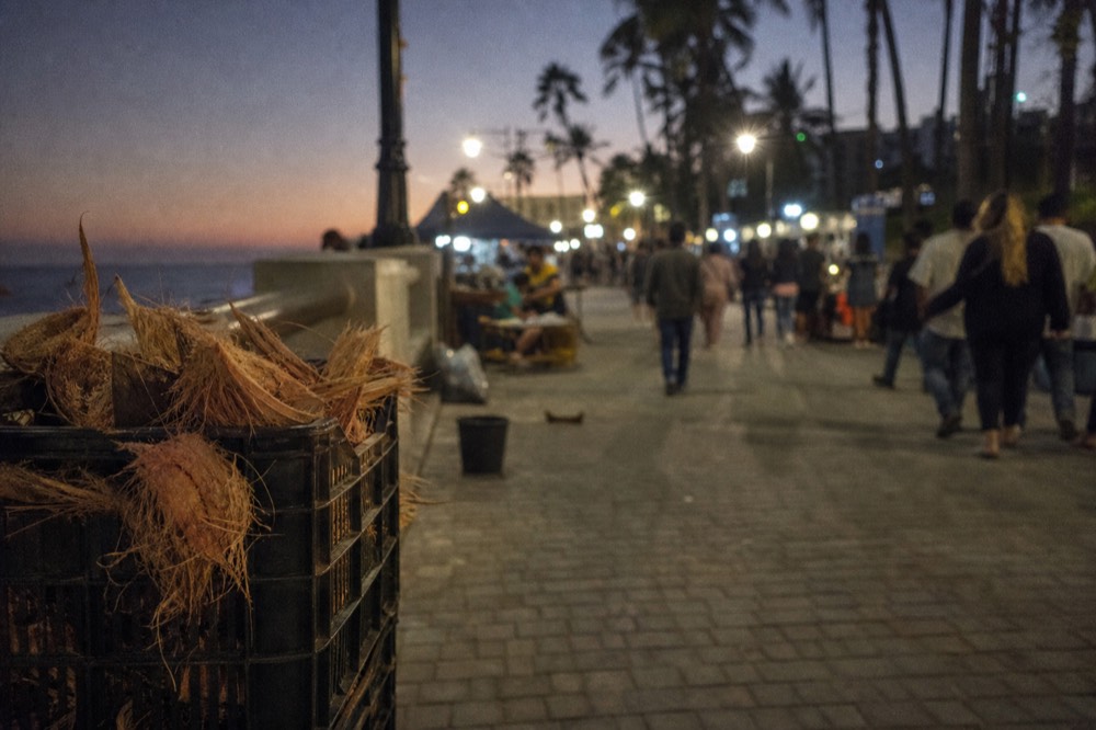 Street performers and vendors along the Mallory Square boardwalk at dusk in Key West, no text, no logos, no people