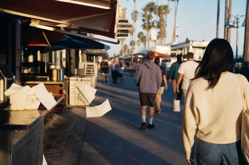 Golden evening light on a boardwalk with food stalls and palm trees in Key West, no text, no logos, no people
